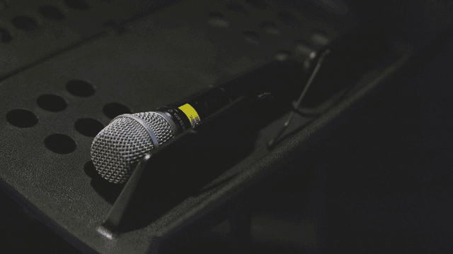 Microphone on a stand in a dimly lit room