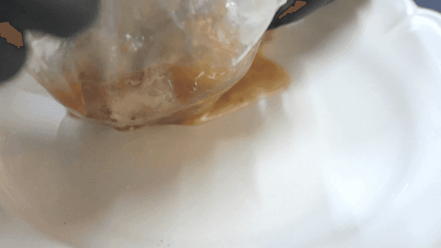 Vacuum-sealed meat being prepared on a plate