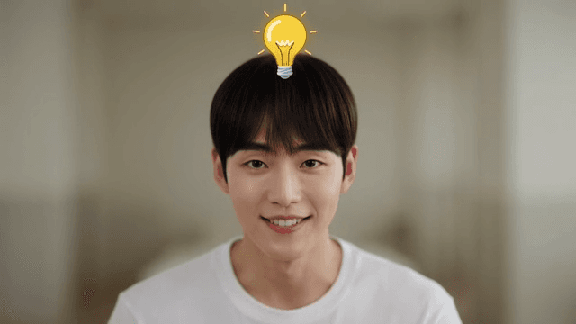 Smiling young man with light bulb on his head