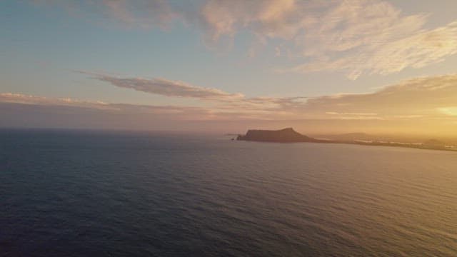 Sunset over the ocean with distant islands