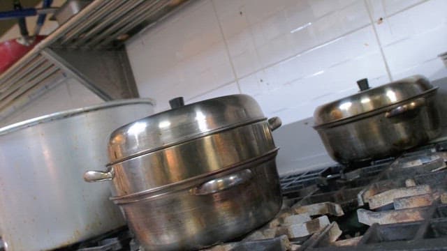 Cooking pots on stove in commercial kitchen