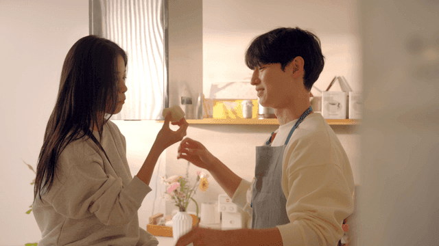 Couple enjoying bread and coffee in kitchen