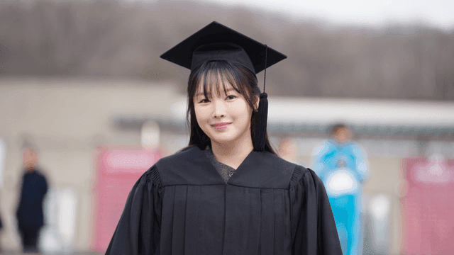 Smiling graduates wearing graduation caps and gowns
