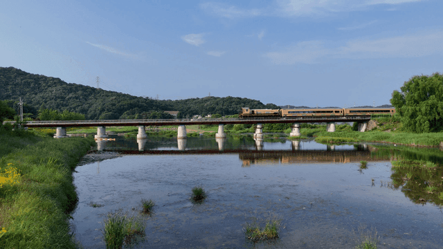 Train crossing a bridge over a river