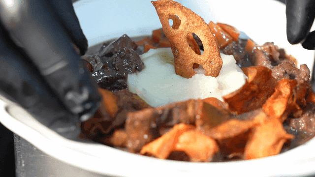 Beef Bourguignon garnished with crispy chips