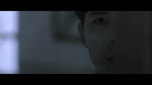 Student concentrating in dark classroom