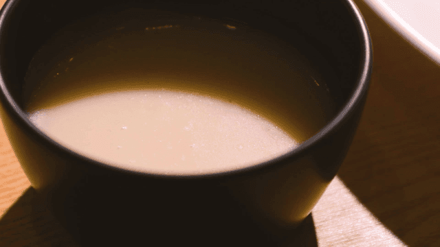 Bowl of creamy soup on a wooden table