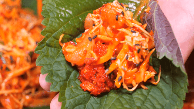 Spicy raw fish salad wrapped in perilla leaves