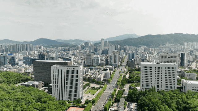 Bustling city with high-rise buildings and greenery.