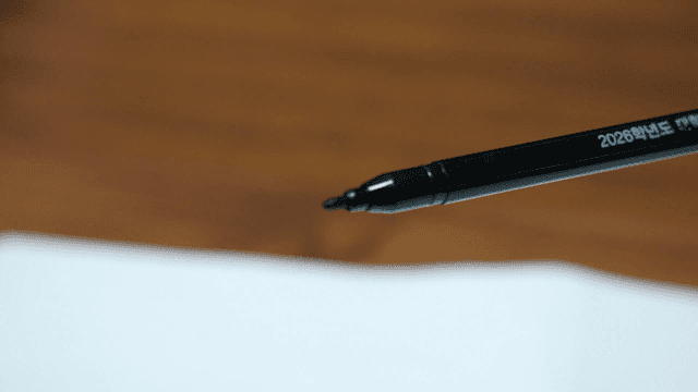 Hand holding computer-based marker pen for CSAT