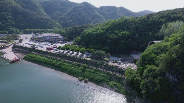 Riverside Scenery with Parking Lot under the Mountains