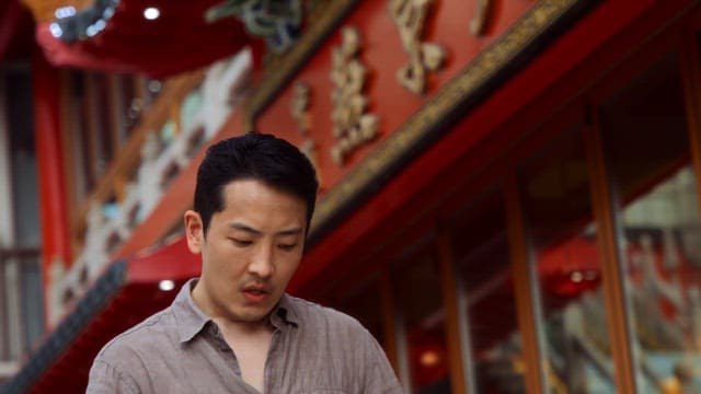 Man looking around in front of a building