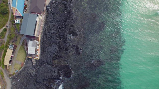 Coastal view with rocky shoreline and buildings