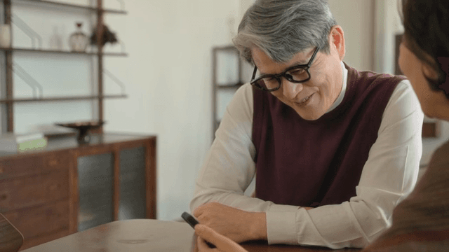 Elderly couple video calling indoors
