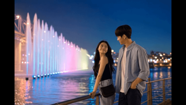 Couple enjoying a colorful bridge fountain
