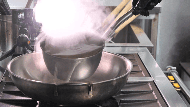 Ladle for pouring broth into pan in kitchen