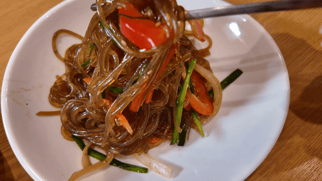 Chopsticks for picking up japchae with vegetables