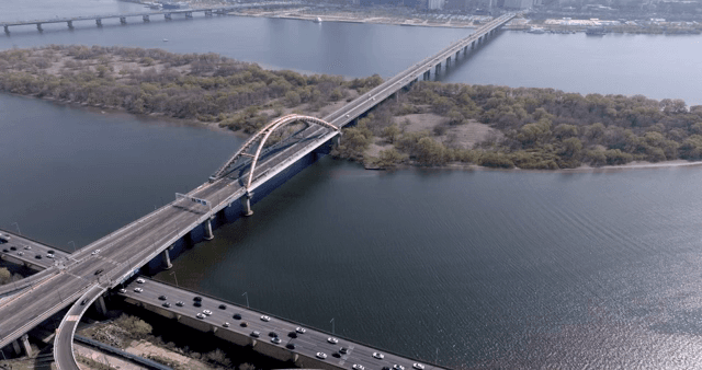 A bridge over a river with cityscape
