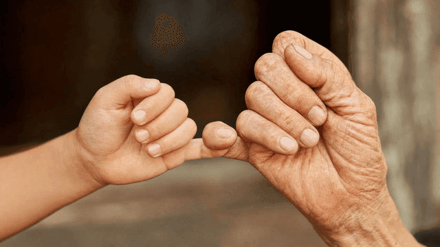 Image of child's little finger holding old man's finger