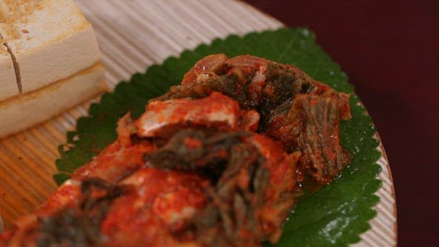 Kimchi with large-eyed herring and tofu on a plate