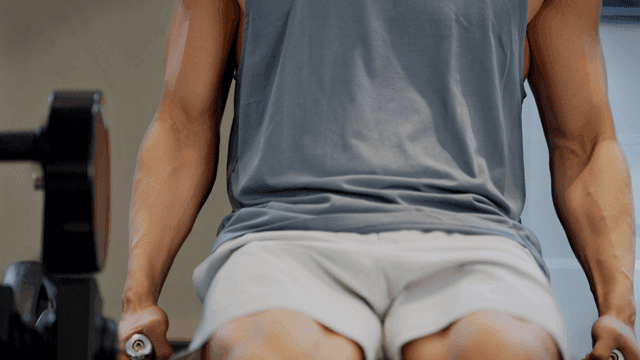 Man exercising on a machine in a gym