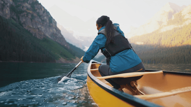 Person kayaking on calm lake