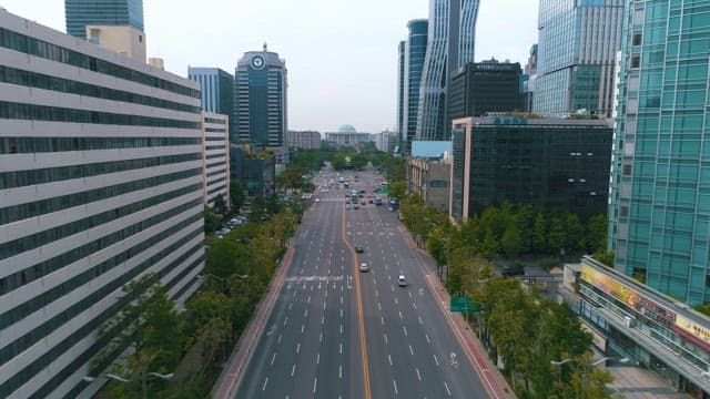 Traffic on a Four-Lane Street Between Dense Buildings