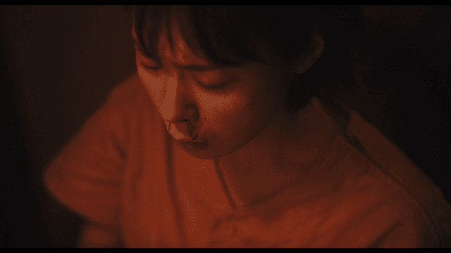 Woman with a nosebleed looking distressed