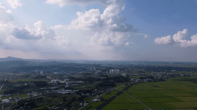 Vast farmland under cloudy sky