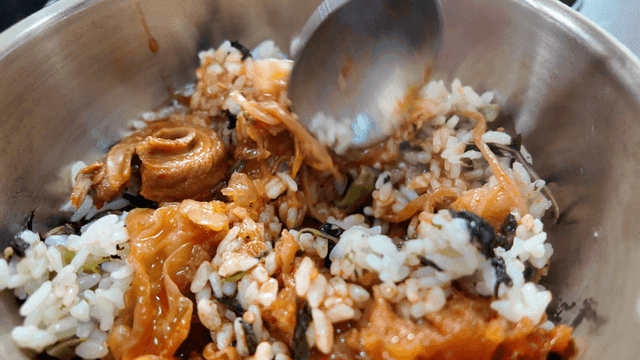 Rice bowl mixed with broth in metal bowl
