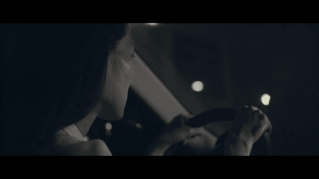 Woman driving at night