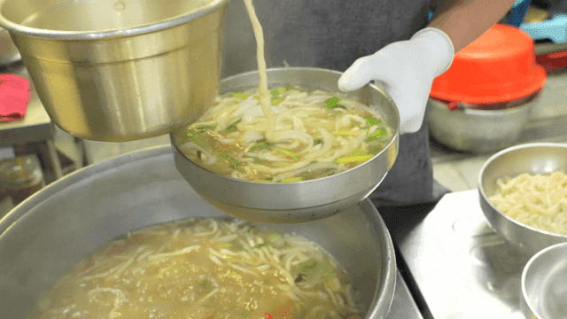 Hand-cut noodles served in a bowl in kitchen