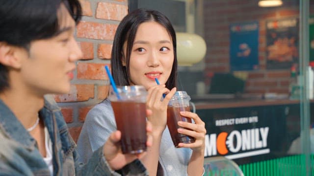 Couple enjoying iced coffee outdoors