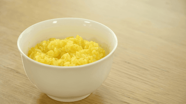 Yellow turmeric rice on wooden table