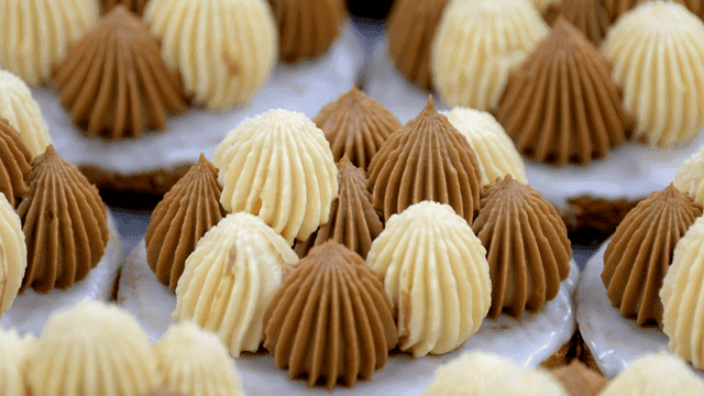 Assorted cream-topped desserts on display