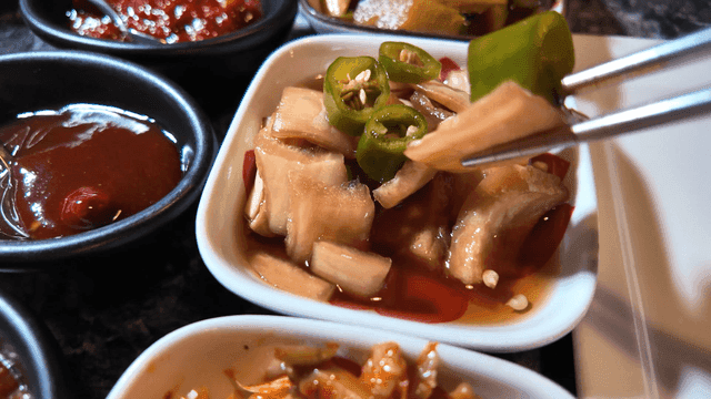 Chopsticks for picking up various restaurant side dishes on table