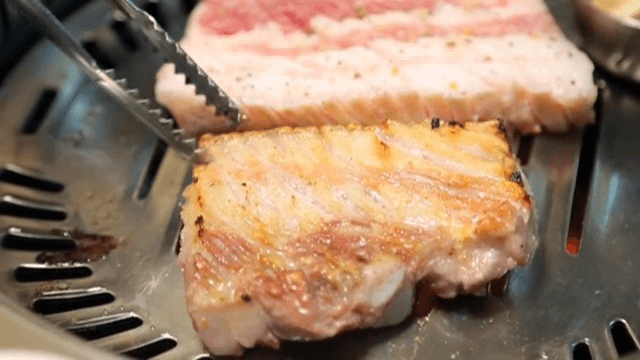 Grilling Grilled Pork Belly on a barbecue grill