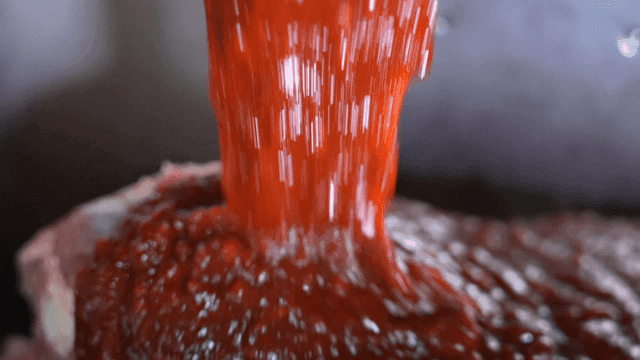 Meat with gochujang poured into container