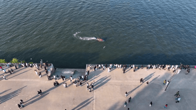 People enjoying a riverside promenade
