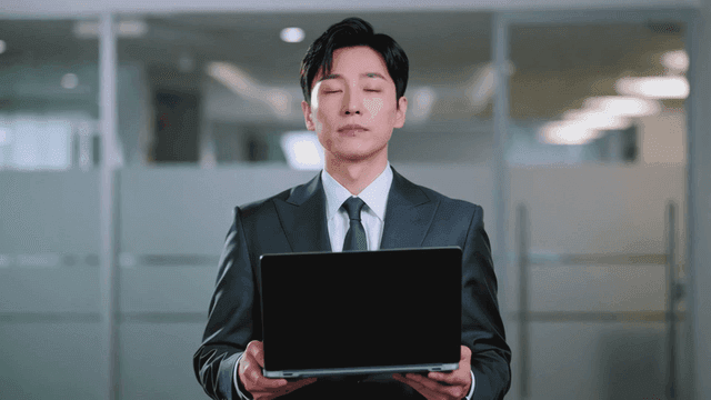 Businessman holding a laptop in an office
