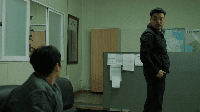 Two men in an office having a conversation