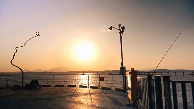 Sunset view over the ocean with sculpture