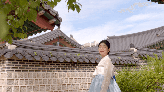 Woman in hanbok at a traditional Korean house