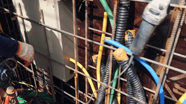 Worker handling cables at a construction site