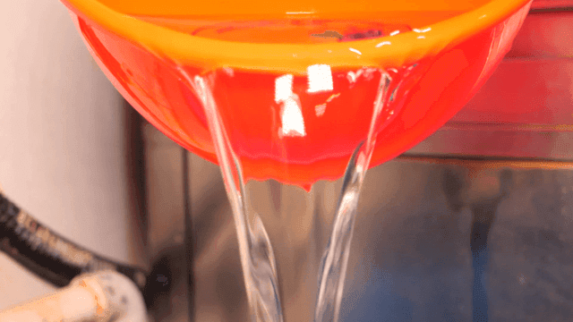 Water pouring from red bucket
