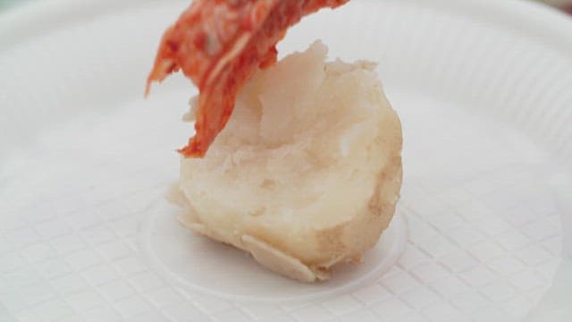 Placing Spicy Kimchi on a Boiled Potato with Chopsticks