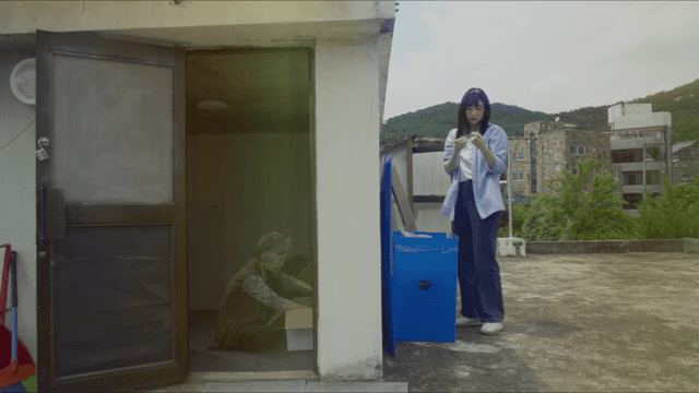 Young woman and old woman packing up luggage on rooftop