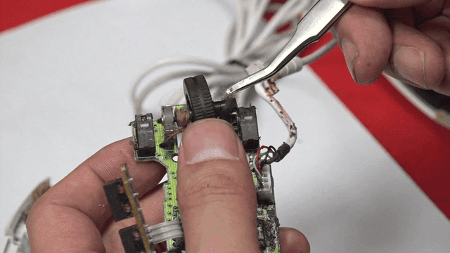 Cleaning computer mouse wheel with tweezers
