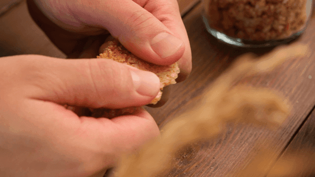Hands breaking crispy scorched rice