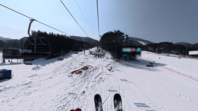 View of ski lift going up snow-covered slope